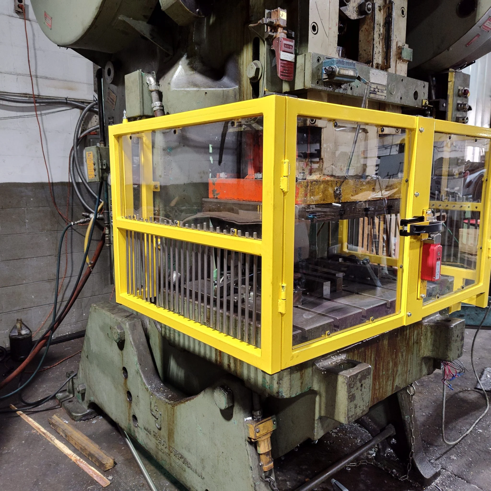 Custom yellow interlocked guard on a hydraulic press