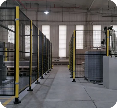 Yellow steel mesh perimeter guard installed around industrial equipment
